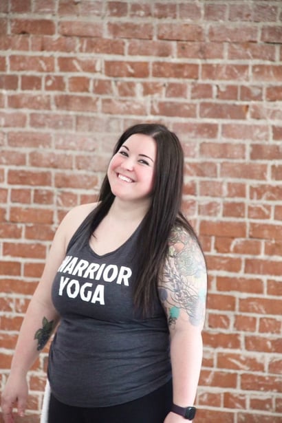 JRP Health Client Before and after transformation photos of a woman in a 'WARRIOR YOGA' tank top, smiling against a brick wall backdrop, highlighting her weight loss progress, vibrant personality, and commitment to her fitness journey